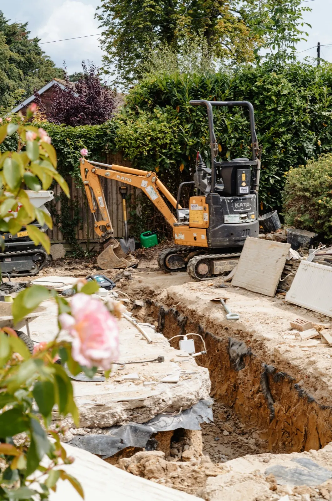Garden trench exposing underground drainage
