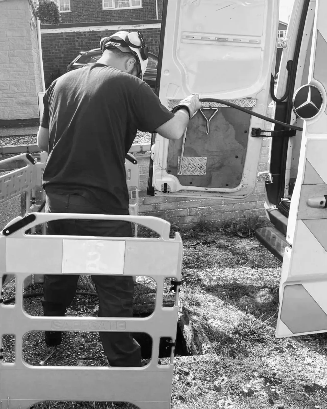 Engineer jetting a drain using equipment from the drainage van